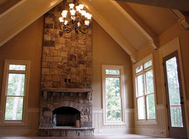 The keeping room with stacked stone fireplace.