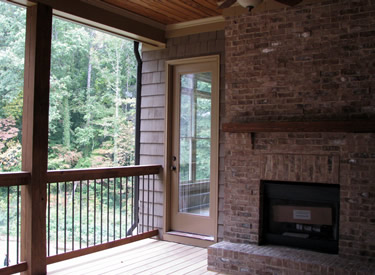The covered porch with brick fireplace.