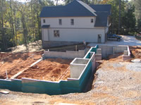 The basement walls have been poured and the water proofing applied.