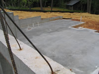 The basement plumbing is in place and the slab has been poured.
